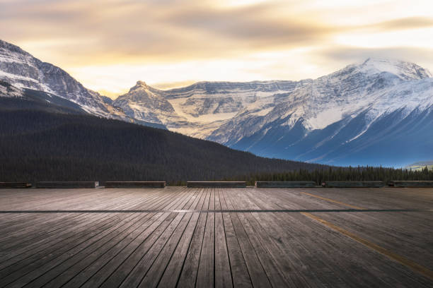 istock Sunset view of snowy mountains with empty patio on foreground 1184512172