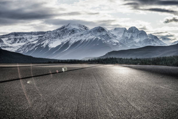 istock Empty road towards rocky mountains 1184512284