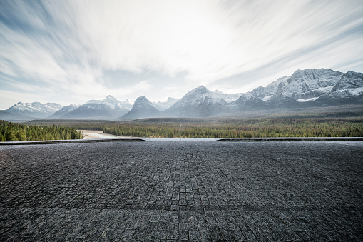 Empty tarmac road with dramatic landscape on background,Banff,Alberta,Canada.
