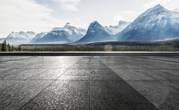 istock empty observation patio front of snowy mountains 1184513135