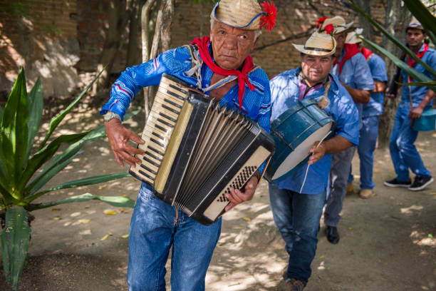 Caruaru, Pernambuco, Brazil - July 11, 2016: Men wearing traditional clothes and straw hat plays accordion during Brazilian June parties (São João)