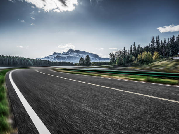 istock Empty road travel through forests and mountains 1184514279