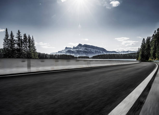 istock Empty road travel through forests and mountains 1184514335