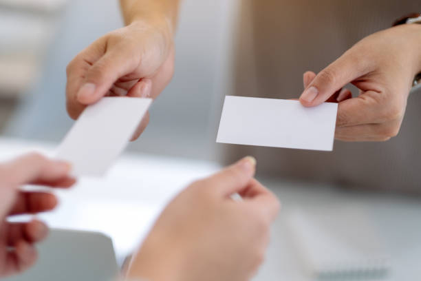 istock businessman holding and exchanging empty business card 1184514946