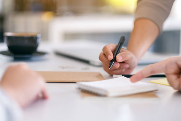 istock businessman discussing and writing on notebook on the table in office 1184515485