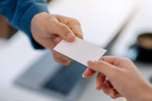 istock Two businessman giving empty business card 1184516056
