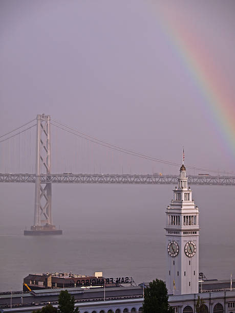 rainbow sobre ferry building & puente de la bahía - bay bridge san francisco county san francisco bay area landscaped fotografías e imágenes de stock