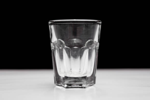 istock Shot glass on white and black background 1184520327