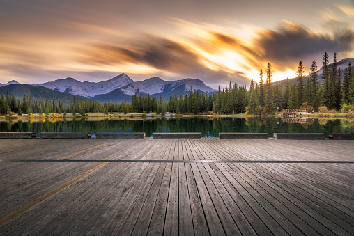 Empty wooden deck front of Forget-Me-Not Pond at twilight,Alberta,Canada.