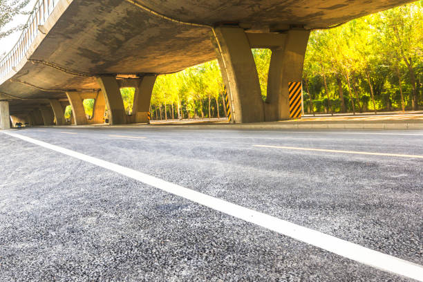 istock Under the backlight, under the overpass asphalt road, car advertising road material 1184528663