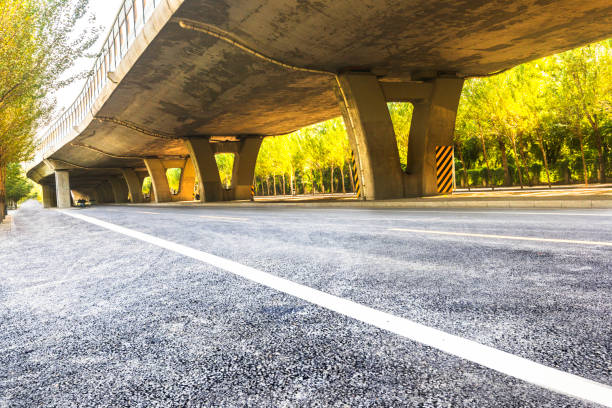 istock Under the backlight, under the overpass asphalt road, car advertising road material 1184528778