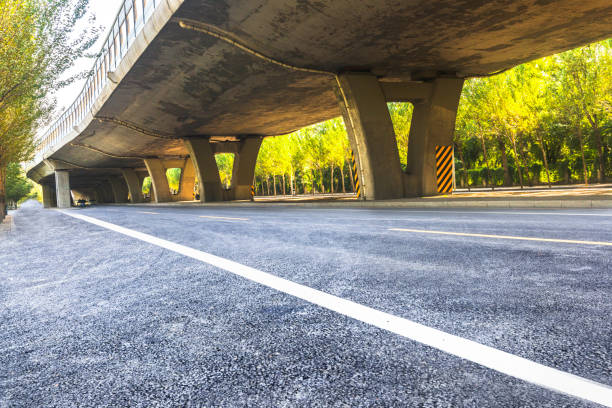 istock Under the backlight, under the overpass asphalt road, car advertising road material 1184528843