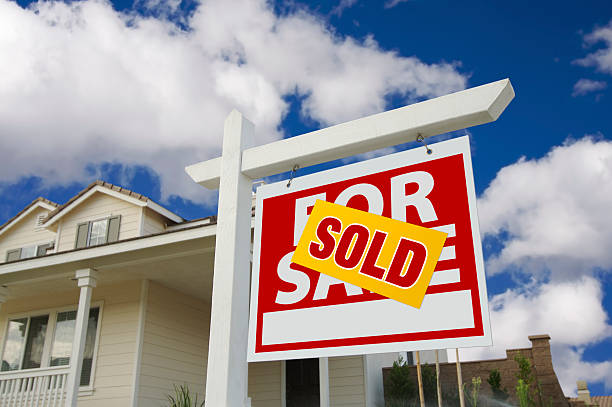 Sold Home For Sale Sign in Front of New House Sold Home For Sale Sign in Front of Beautiful New House. houses for sale stock pictures, royalty-free photos & images