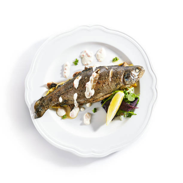 istock Rainbow Trout on a Vegetable Pillow with Creamy Caviar Sauce 1184529704