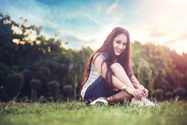 istock Indian Woman tying shoe laces 1184529706