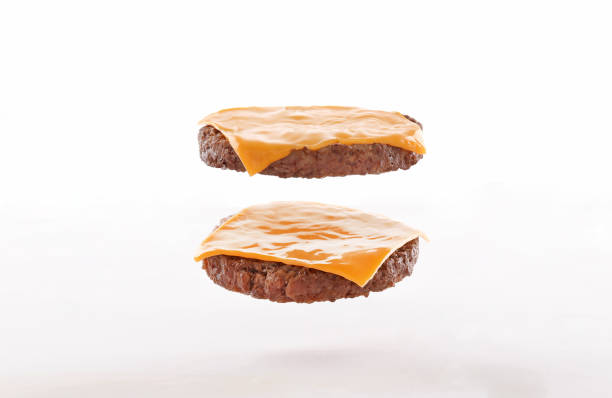 burger steaks, fly, float with cheese on white background - hamburger burger symmetry cheeseburger imagens e fotografias de stock