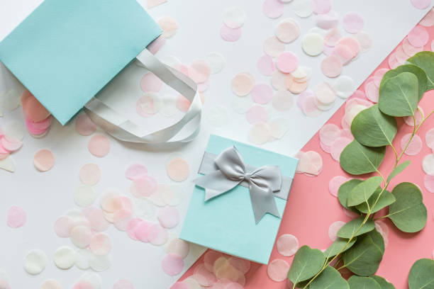 istock Gift or present box and confetti on pink table top view. Flat lay composition for birthday, mother day, 8 march, xmas, christmas, new year, valentine day or wedding. Holiday concept 1184540577