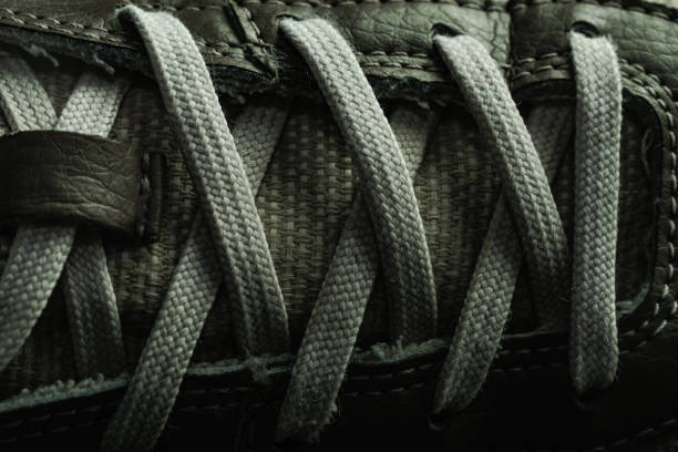 istock Beautiful white shoeloces on a dark background texture. 1184549692