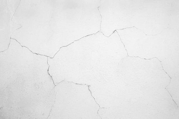 istock White pastel rough crack cement texture stone concrete,rock plastered stucco wall; painted flat fade background gray solid floor grain. 1184549751