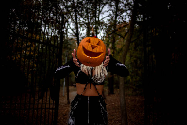 istock Girl with pumpkin 1184554300