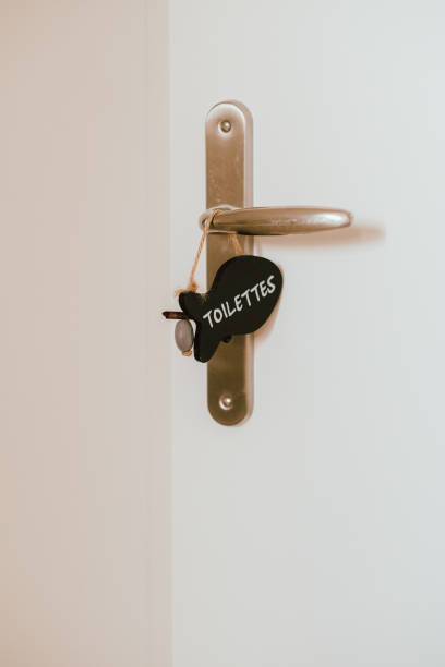 istock Open toilet door with label sign on the handle 1184557948