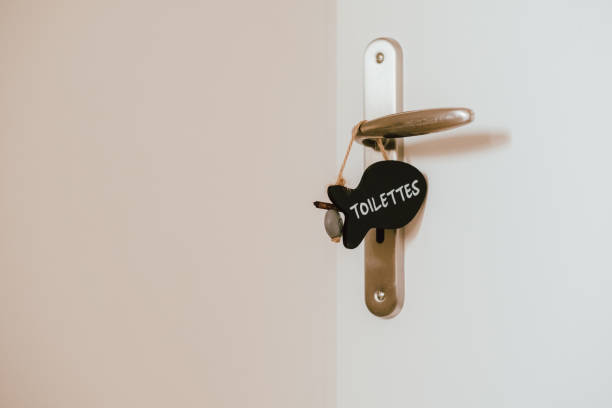 istock Open toilet door with label sign on the handle 1184557952