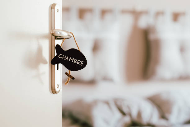 istock Open bedroom door with label sign on the handle 1184558008