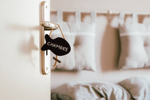 istock Open bedroom door with label sign on the handle 1184558037