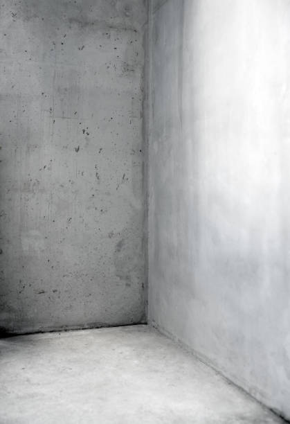 istock Exposed concrete wall not plastered or veneered - viewing surfaces - design functions in the room 1184559262