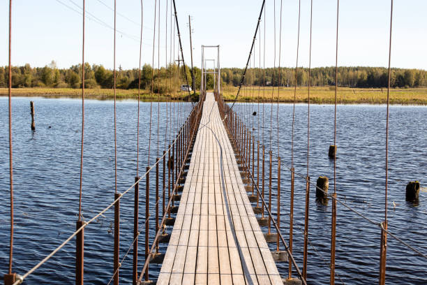Suspension bridge across the river Tsna in the village Asviha Tver region Russia