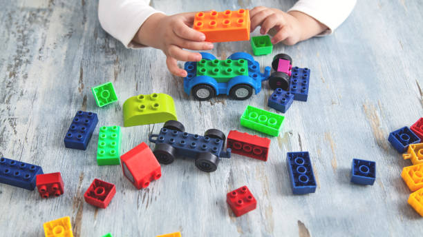 istock Little girl playing with colorful construction plastic blocks. 1184560524