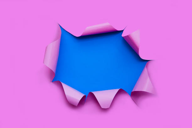 istock Abstract background hole in paper over pink background. Through paper. Copy space 1184561438
