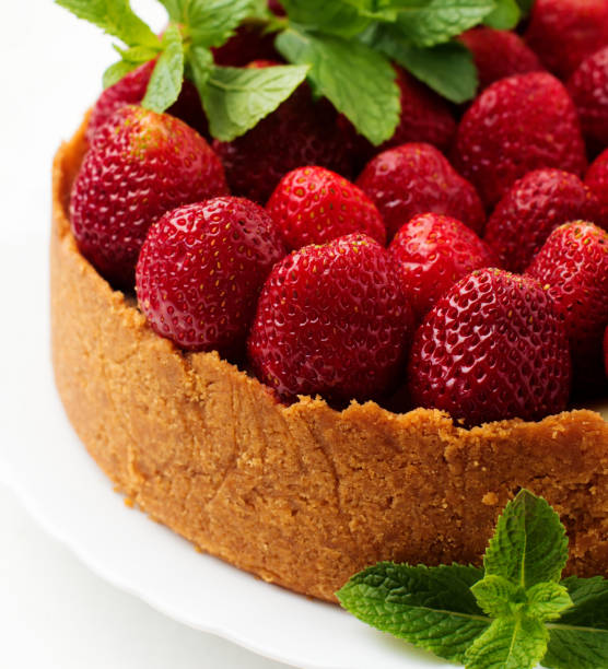 istock Cheesecake with fresh strawberries and mint on white plate on gray concrete background. Square image. Top view. 1184565218