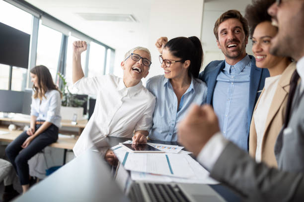 istock Group of successful business people at work in office 1184566243