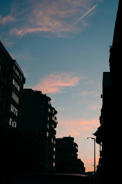 istock Low Angle View Of Silhouette Buildings Against Sky At Sunset 1184568882