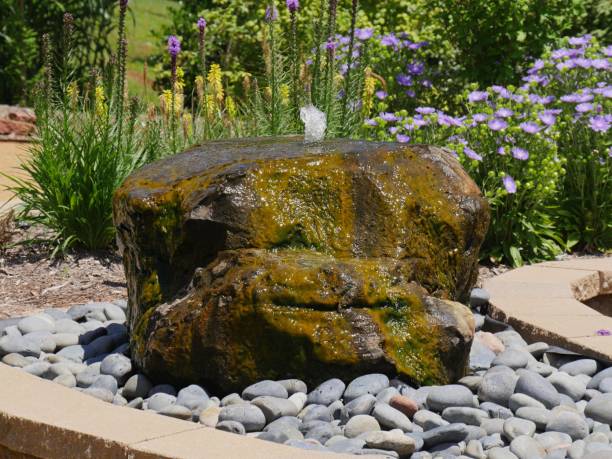 istock Big rock with water fountain 1184569189