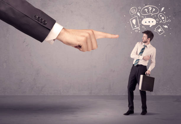 istock Boss hand pointing at confused employee 1184570061