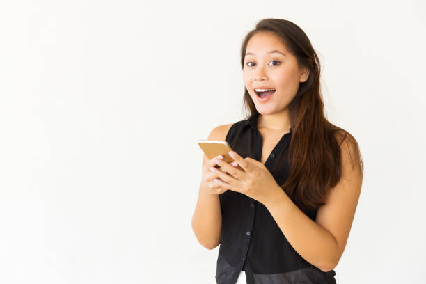 istock Surprised young woman using smartphone 1184570147