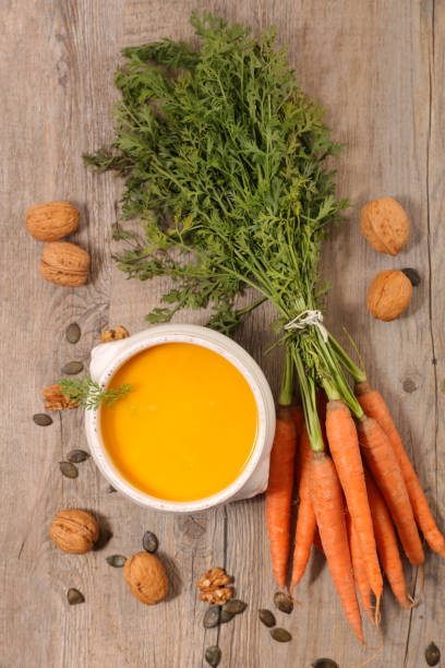 istock carrot and walnut soup on wood background 1184570198