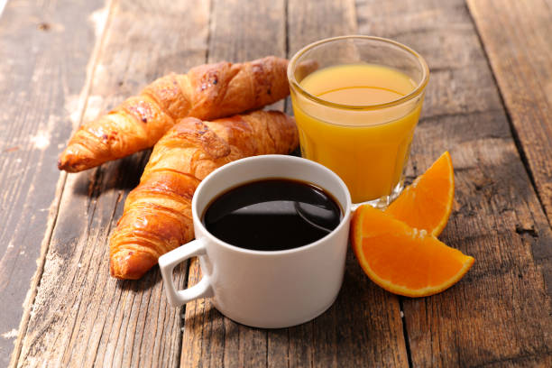 istock coffee cup with croissant and orange 1184570232