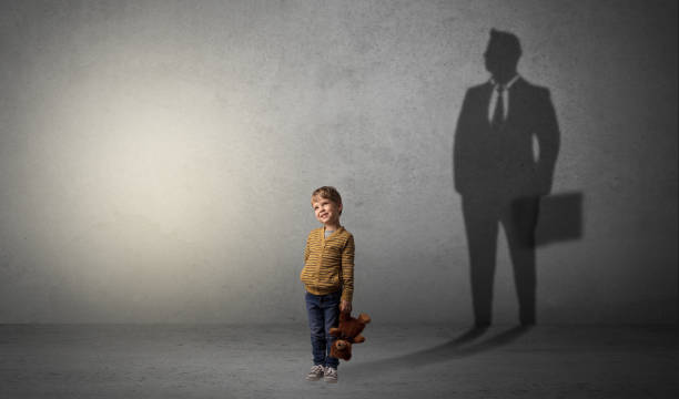 istock Little boy with businessman shadow 1184572052