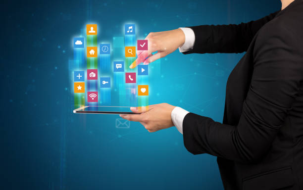 istock Classic application icons coming out from tablet 1184574426
