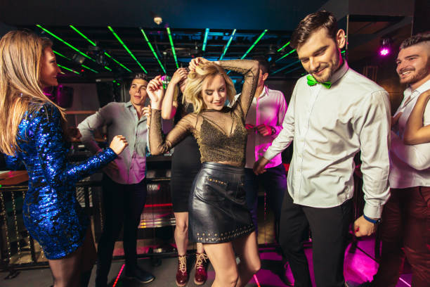 istock Young people dancing in night club 1184576636