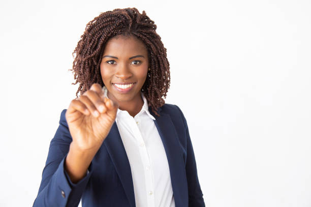 istock Happy friendly business trainer writing on glass board 1184579190