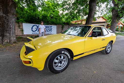 Hungary Szodliget Jun 22, 2019: A yellow vintage Porsche Coup Sports model just crossed the finis liner in a mint condition.