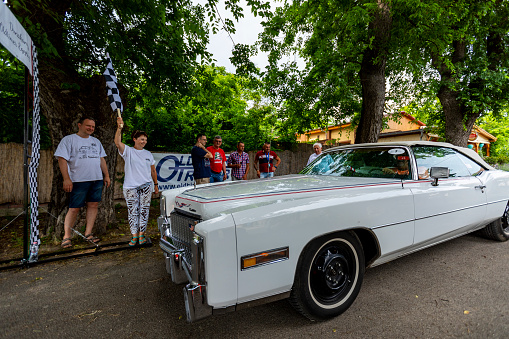 Hungary Szodliget Jun 22, 2019:A gray colour vintage Cadillac sedan from the '80s just finished the race in a mint condition.