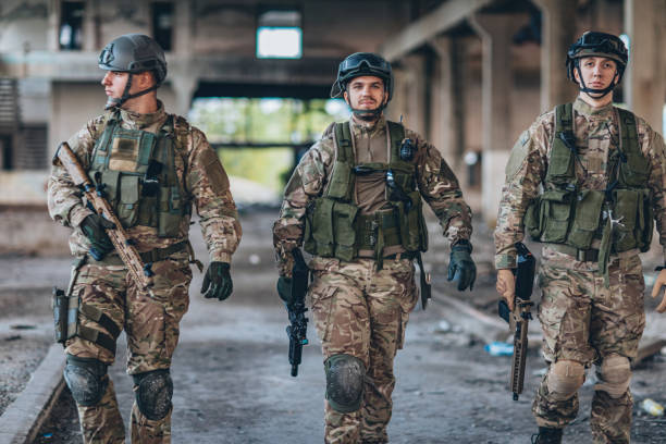istock Army men walking in abandoned warehouse 1184582823