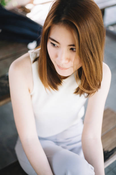 istock cute asian women holding roses 1184583432