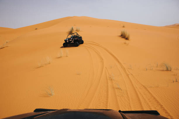 istock Off road buggies crossing dunes in the desert. 1184584130