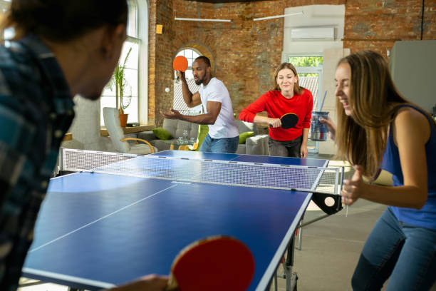 istock Young people playing table tennis in workplace, having fun 1184584293